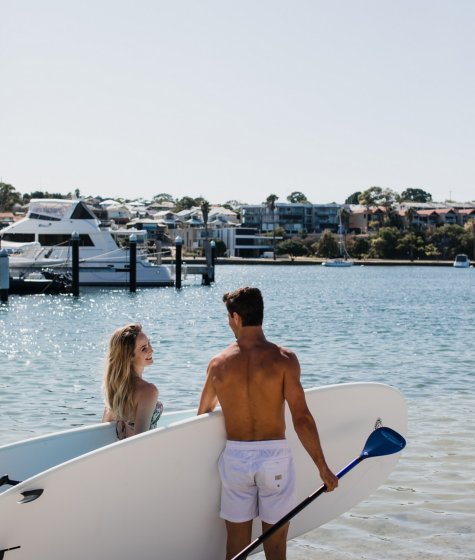 Couple paddleboarding together in Fremantle Image