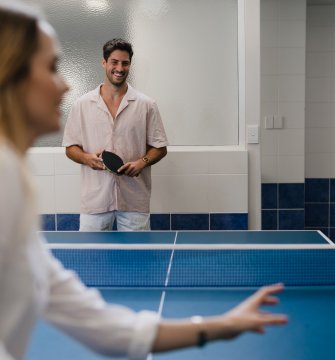 A couple plays table tennis at Pier 21