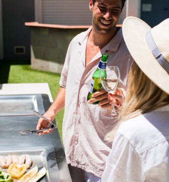 Two hotel guests cooking a barbecue lunch