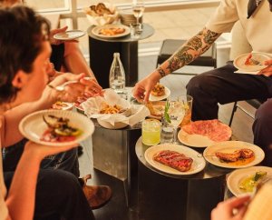 A group of friends enjoy finger food and cocktails at Al Lupo, a bar in Fremantle