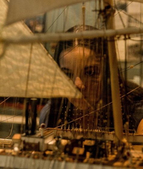 A child and adult looking at a boat exhibition at the wa maritime museum Image