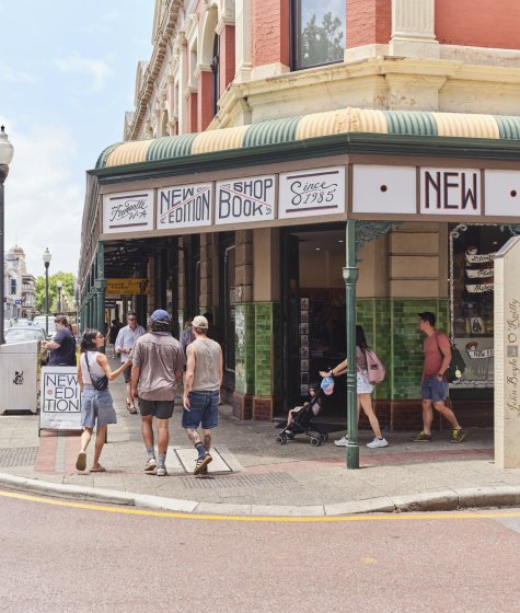 A shop on the corner of a Fremantle street with people walking past it Image